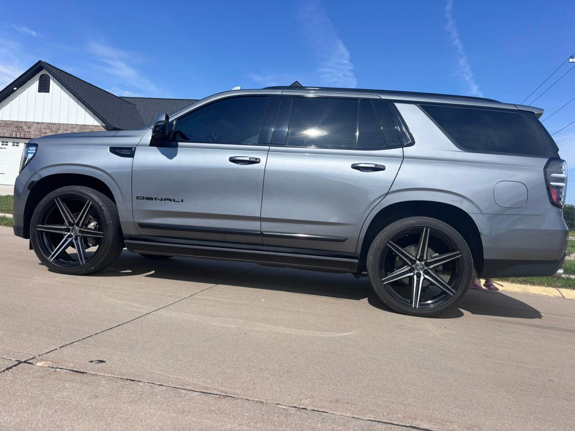 Gray GMC Yukon Denali with custom black and machined wheels