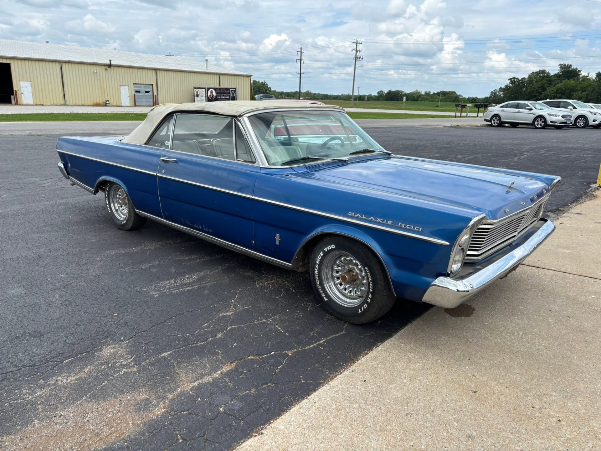 Blue Ford Galaxie convertible with white top after restoration