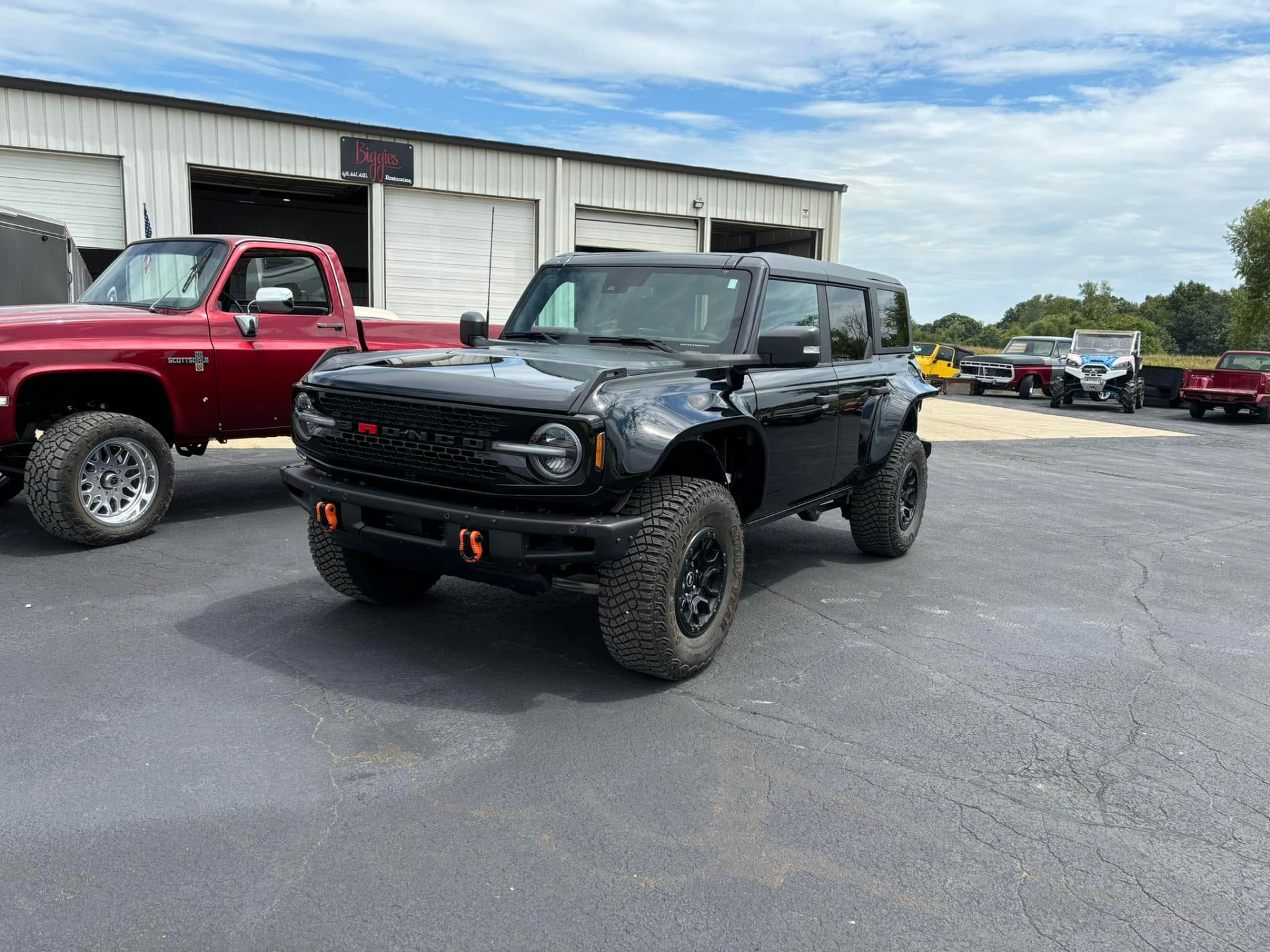 Black Ford Bronco Raptor parked outside the shop