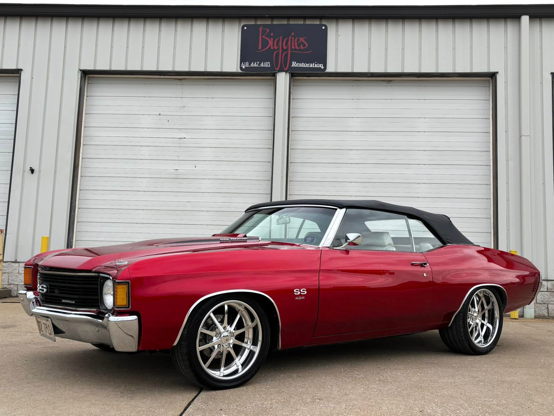 Candy red Chevelle convertible with chrome wheels after restoration